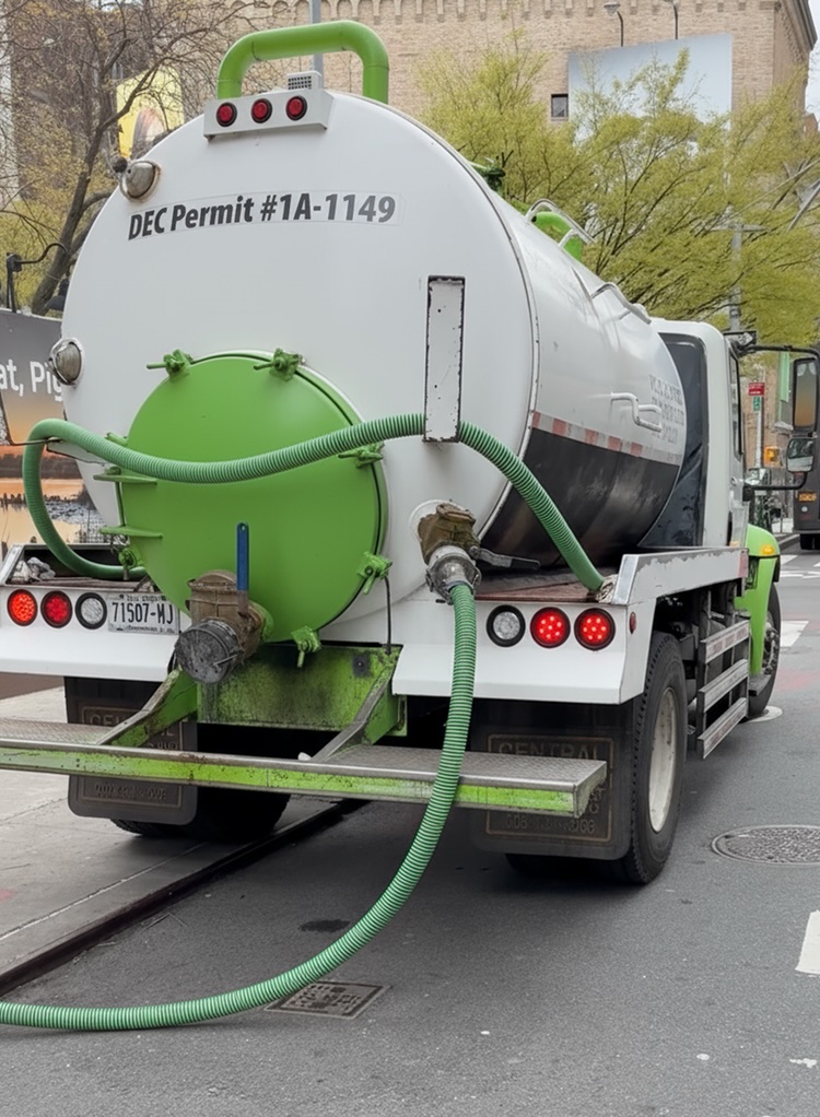 Bio Energy Development vacuum tanker truck with DEC Permit #1A-1149 servicing a grease trap on a New York City street